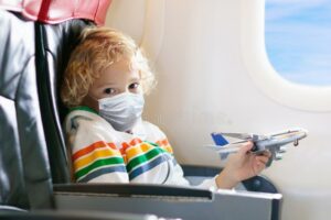 child in mask on plane